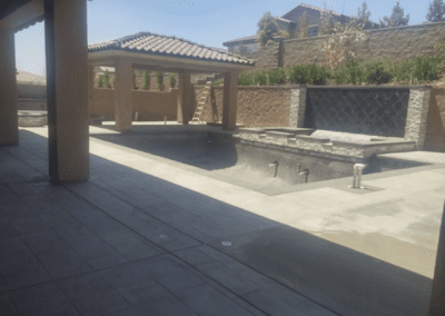 A backyard with a pool and a gazebo.