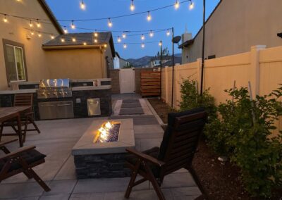 A backyard with a fire pit and outdoor furniture.